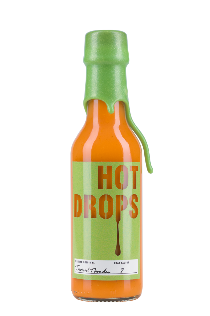Picture of hot sauce bottle, the sauce is Tropical Thunder – made with pineapples, habanero peppers, turmeric carrots, onions and garlic.